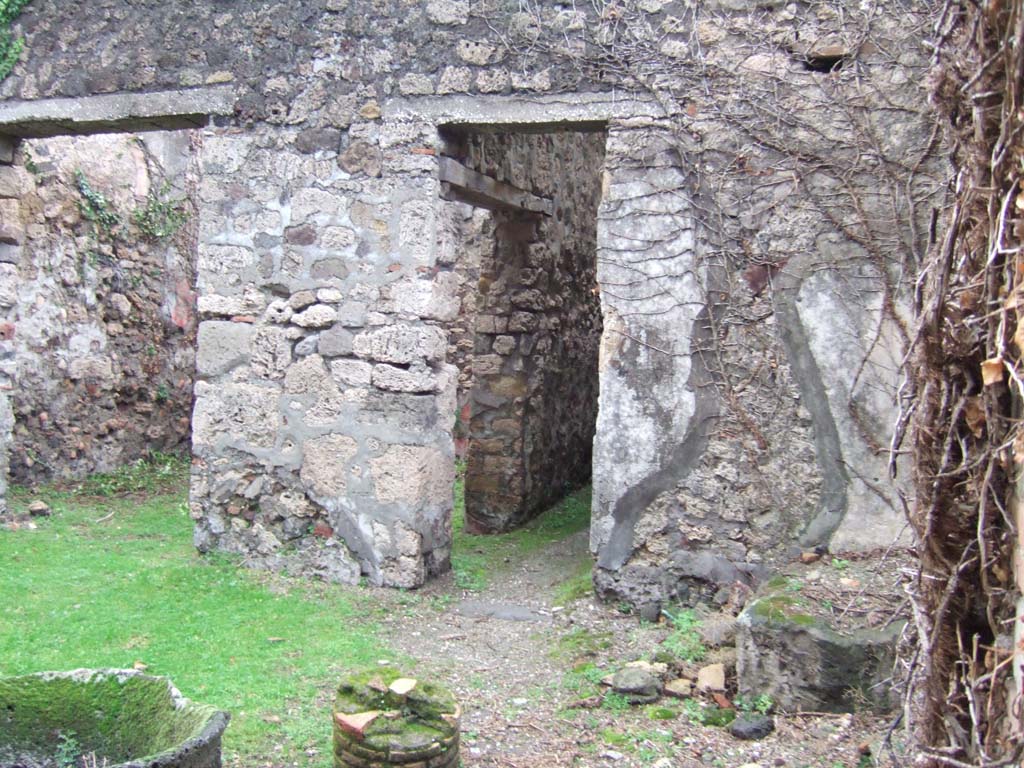 VII.2.51 Pompeii. December 2005. 
Looking east across viridarium at exedra in north-east corner and corridor leading to kitchen and oven.
