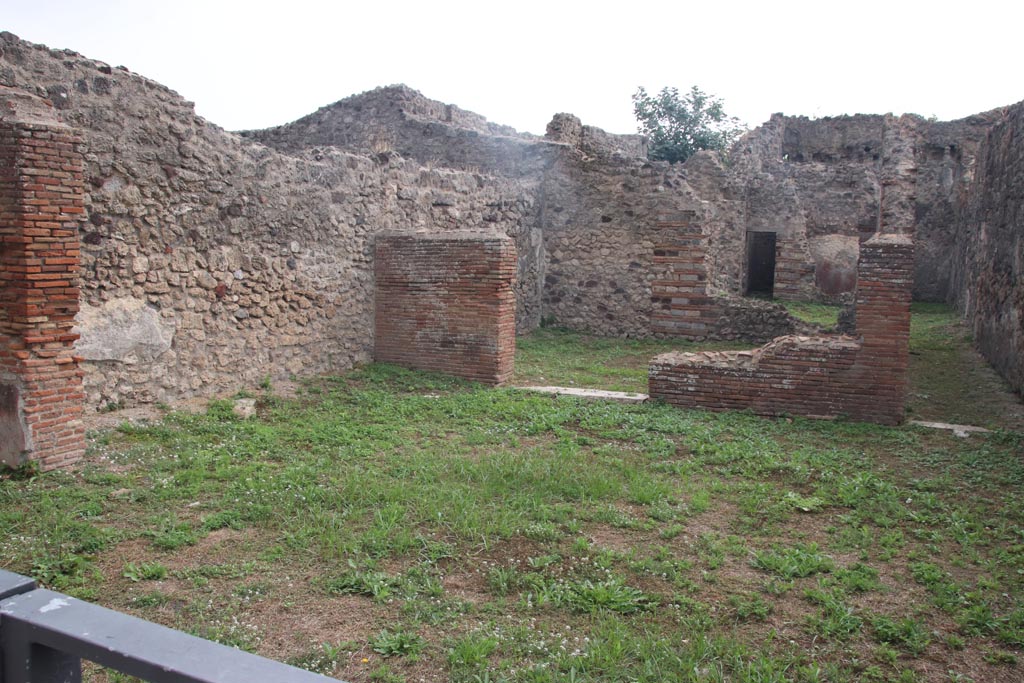 VII.3.8 Pompeii. October 2023. 
Looking across shop-room towards doorway to tablinum (a), in centre, and corridor (b) to rear rooms, on right. 
Photo courtesy of Klaus Heese.
