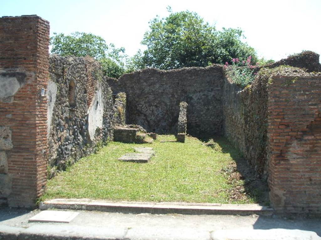 VII.3.10 Pompeii. May 2005. Looking south across shop. According to Helbig, on the outside wall between VII.3.11 and VII.3.10, on the left, there was a faint trace of a painted Lar with a situla. See Helbig, W., 1868. Wandgemlde der vom Vesuv verschtteten Stdte Campaniens. Leipzig: Breitkopf und Hrtel. (no: 93)
