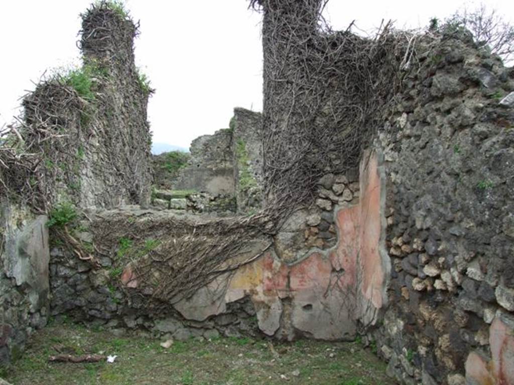 VII.3.12 Pompeii. March 2009. South wall of rear room of shop, showing a red zoccolo/dado, red side panels and central yellow panel.