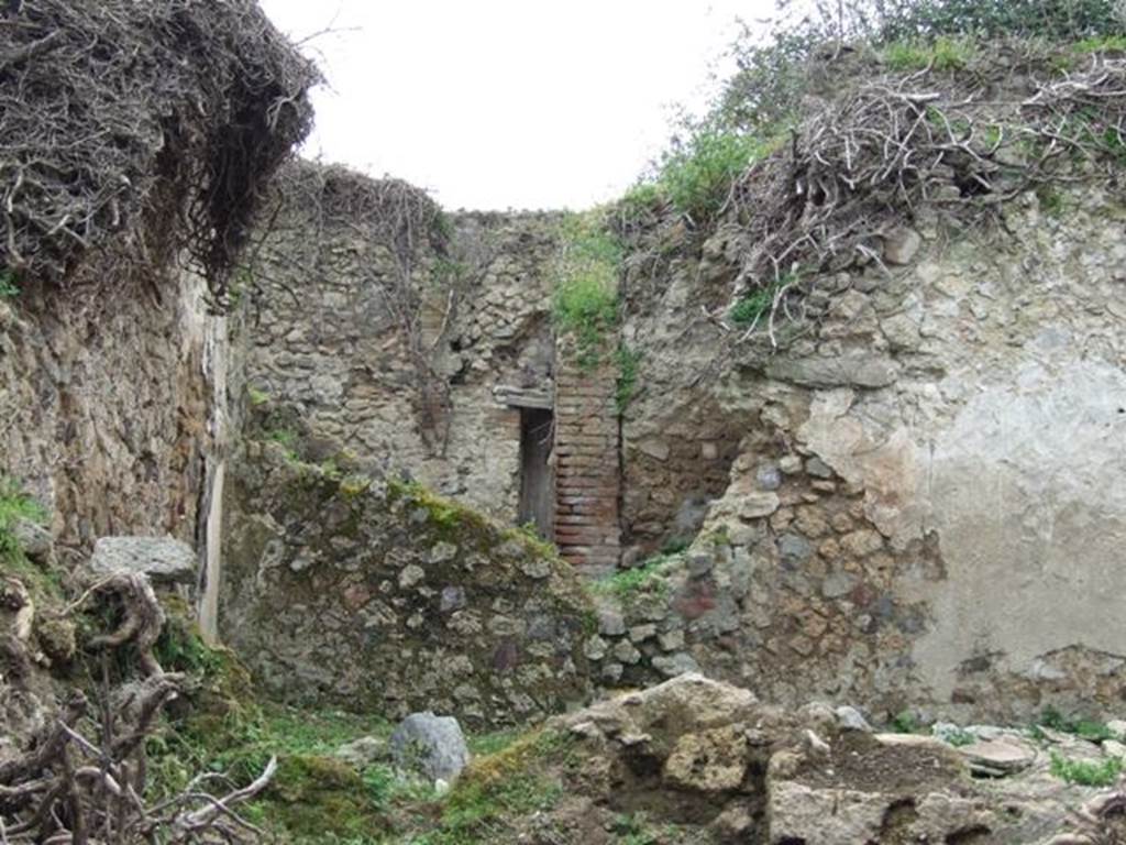 VII.3.21 Pompeii. March 2009. Looking west towards garden area of VII.3.21.  This is at the rear of the triclinium of VII.3.13, in the foreground.  Apart from the garden area, there was also a small room or cupboard, kitchen and latrine. According to Boyce, in the east wall of the kitchen between the hearth and the latrine, was a small rectangular niche. Inside the niche, its walls were coated with red stucco.
See Boyce G. K., 1937. Corpus of the Lararia of Pompeii. Rome: MAAR 14. (p. 64, no. 268) 

