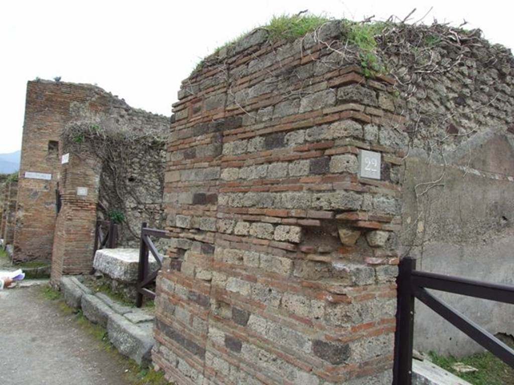 VII.3.23 Pompeii. March 2009. Wall south of VII.3.22, with terracotta and tufa plaque.