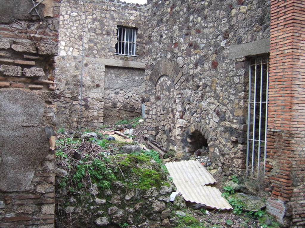 VII.3.28 Pompeii. December 2005. Looking towards east wall of bar, with a blocked doorway leading to VII.3.26, under the stairs at VII.3.27.