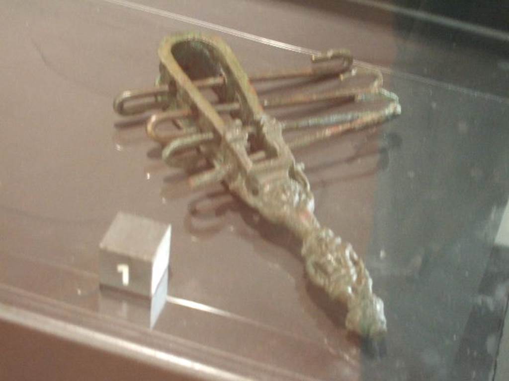 Bronze Sistrum found in VII.4.13.  Now in Naples Archaeological Museum.