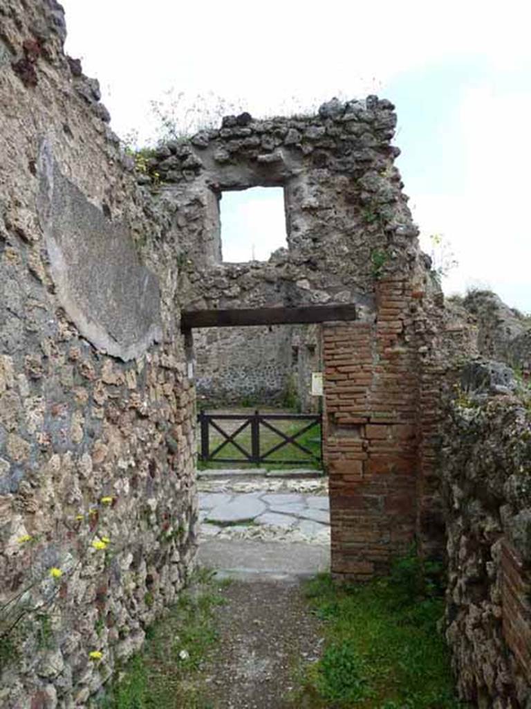 VII.4.41 Pompeii. May 2010. Looking east to entrance doorway from Vicolo Storto. The steps to the upper floor would have been along the wall, on the right. 
