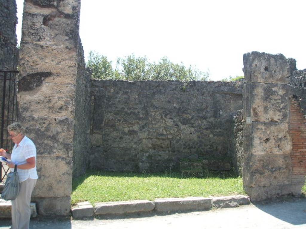 VII.4.52 Pompeii. May 2005. Looking south from entrance across shop.
According to Eschebach, on the left was a small arched niche. On the right at the rear was a staircase to the upper floor with a latrine  beneath.
See Eschebach, L., 1993. Gebudeverzeichnis und Stadtplan der antiken Stadt Pompeji. Kln: Bhlau. (p.282)
According to Boyce, in the west wall was a rectangular niche and in the east wall was an arched niche. One of them was probably a Lararium.
See Boyce G. K., 1937. Corpus of the Lararia of Pompeii. Rome: MAAR 14. (p.66, no.280) 

Graffito was found in April 1833 on the pilaster on the right, between VII.4.52 and 53 
Rufum  d(ignum?)  []
L(ucium)  Nu[mis]iu[m
De[]      [CIL IV 287]
See Pagano, M. and Prisciandaro, R., 2006. Studio sulle provenienze degli oggetti rinvenuti negli scavi borbonici del regno di Napoli. Naples : Nicola Longobardi. (p.147)
