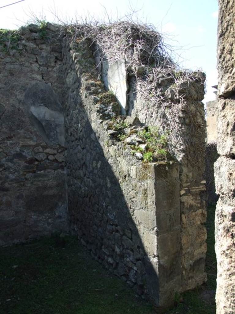 VII.4.57. Pompeii.  March 2009. Room 11.  Cubiculum. North wall with small doorway to Room 12. Note the double wall with plaster in between.