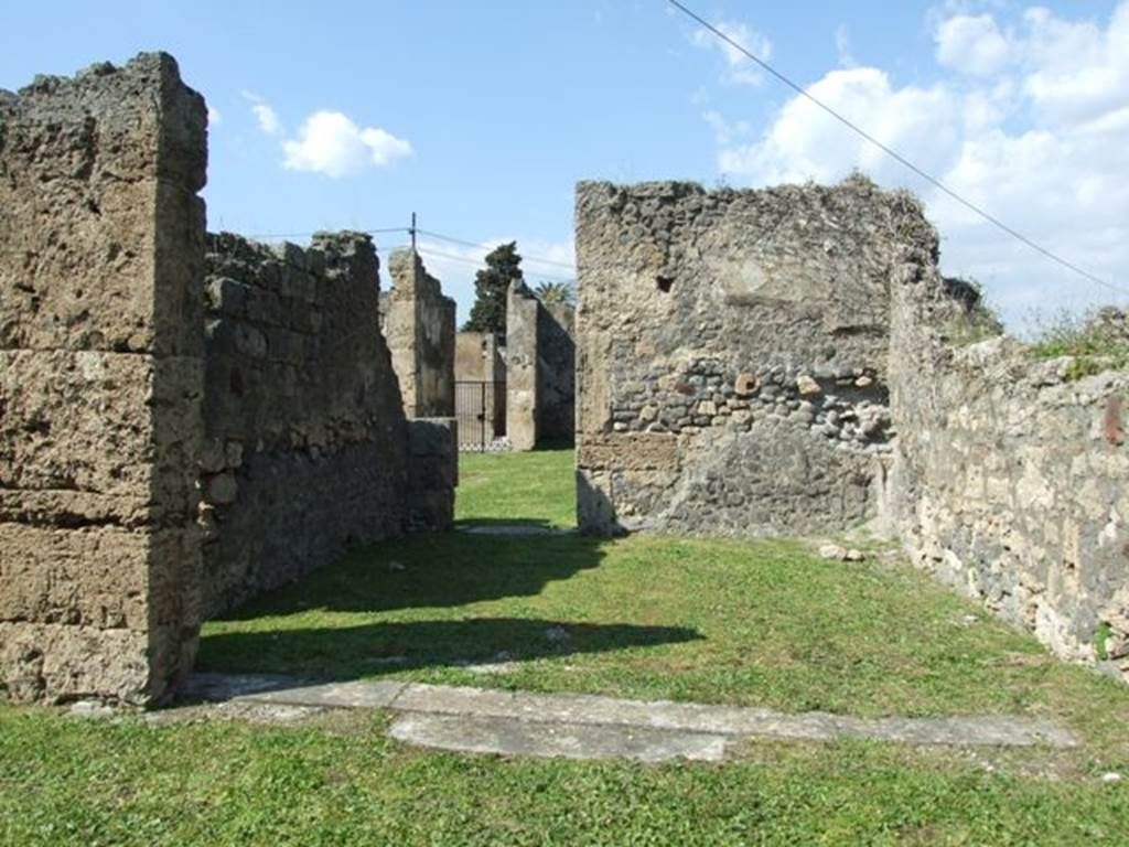 VII.4.57. Pompeii.  March 2009. Room 15.  Exedra.  Looking north to small door in rear wall connecting with Room 1. Atrium.