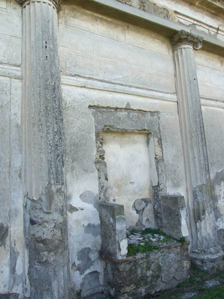 VII.4.57 Pompeii. March 2009. Remains of aedicula Lararium against west wall of peristyle.
According to Boyce, a rectangular niche bordered by solid walls stood upon a masonry base.
See Boyce G. K., 1937. Corpus of the Lararia of Pompeii. Rome: MAAR 14. (p.66, no.282, and Pl.35,3) 
