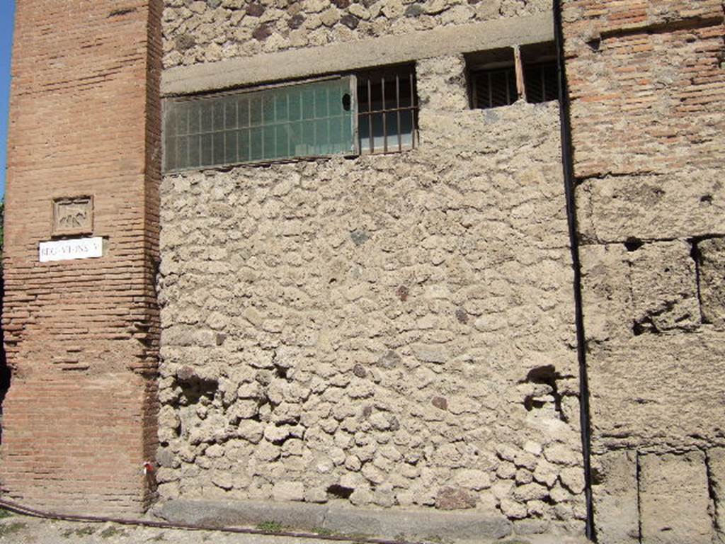 VII.5.14 Pompeii. September 2005. Looking north towards original entrance on south side of insula.  According to Garcia y Garcia, all of the south-west corner and southern part of the insula were transformed in the time of Maiuri. Then the area was hit during the first bombing incursion during the early evening (17.00hrs) of 13th September 1943. All of the old structures have been modified again to provide a restaurant, latrine and sales area. The modifications included closing and bricking up of the old doorways to VII.5.14, 15, 16 and 17. Entrances at VII.5.18, 19 and 20 now provide the doorways to the modern restaurant.  See Garcia y Garcia, L., 2006. Danni di guerra a Pompei. Rome: LErma di Bretschneider. (p.101-3) 

According to Fiorelli, the shop originally had a sales-counter clad largely in marble, and with only one urn of terracotta. At the rear were the stairs to the upper floor, a dormitory, a kitchen with hearth, near to the kitchen was a small stall. See Pappalardo, U., 2001. La Descrizione di Pompei per Giuseppe Fiorelli (1875). Napoli: Massa Editore. (p.96)

According to Boyce, in the east wall was a square niche.
See Boyce G. K., 1937. Corpus of the Lararia of Pompeii. Rome: MAAR 14. (p.66, no.284) 