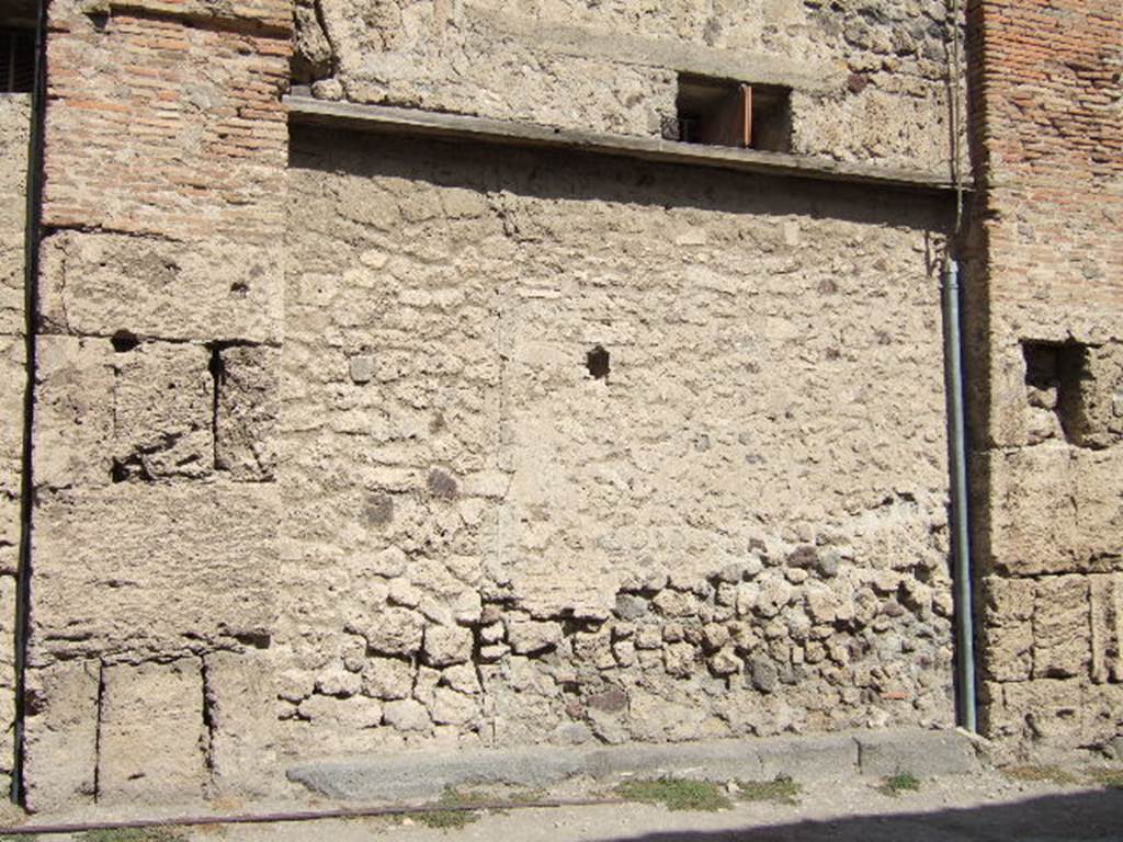 VII.5.15 Pompeii. September 2005. Looking north towards site of doorway to shop.According to Garcia y Garcia, all of the south-west corner and southern part of the insula were transformed in the time of Maiuri.Then the area was hit during the first bombing incursion during the early evening (17.00hrs) of 13th September 1943. All of the old structures that remained have been modified again to provide a restaurant, toilets and sales area. The modifications included closing and bricking up of the old doorways to VII.5.14, 15, 16 and 17. Entrances at VII.5.18, 19 and 20 now provide the doorways to the modern restaurant.  See Garcia y Garcia, L., 2006. Danni di guerra a Pompei. Rome: LErma di Bretschneider. (p.101-3).

On the pilaster between VII.5.14 and VII.5.15, on the left, a painting of two gladiators was found in April 1817. Remaining on the pilaster, it gradually faded. Fiorelli said it was almost vanished when he saw it.  
See Jacobelli, L., 2003. Gladiators at Pompeii. Rome: LErma di Bretschneider. (p. 79) See Helbig, W., 1868. Wandgemlde der vom Vesuv verschtteten Stdte Campaniens. Leipzig: Breitkopf und Hrtel. (1513)

Below the painting of the gladiators were inscriptions painted in red, found 12th April 1818 
Tetraites  Prudes  Prudes  l(udes)  XIIX  Tetraites  l(udes)  X[]
abiat  Venere  <P=B>ompei{i}ana( !)  iratum  qui  hoc  laesaerit     [CIL IV 538]
Marcellum  aed(ilem)  EAMH()  roga(t)     [CIL IV 539]
See Pagano, M. and Prisciandaro, R., 2006. Studio sulle provenienze degli oggetti rinvenuti negli scavi borbonici del regno di Napoli.  Naples : Nicola Longobardi.  (p.116)

According to Boyce, in the main room was a lararium painting on a white background. Either side of an altar stood the Genius and the tibicen, both of the same size, behind the Genius was a large cock. On each side of this group stood a Lar of larger stature than the Genius, wearing green and yellow tunics with red pallium. In the zone below were two serpents moving towards an altar furnished with offerings.
See Boyce G. K., 1937. Corpus of the Lararia of Pompeii. Rome: MAAR 14. (p. 67, no.285). 

According to Fiorelli, this was a shop with two rooms, in the first room was the Lararium, in the second room was a vast latrine.
See Pappalardo, U., 2001. La Descrizione di Pompei per Giuseppe Fiorelli (1875). Napoli: Massa Editore. (p.96)




