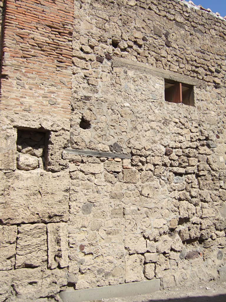 VII.5.16 Pompeii. September 2005. Site of entrance doorway.
According to Garcia y Garcia, all of the south-west corner and southern part of the insula were transformed in the time of Maiuri.
Then the area was hit during the first bombing incursion during the early evening (17.00hrs) of 13th September 1943.
All of the old structures that remained have been modified again to provide a restaurant, toilets and sales area.
The modifications included closing and bricking up of the old doorways to VII.5.14, 15, 16 and 17.
Entrances at VII.5.18, 19 and 20 now provide the doorways to the modern restaurant. 
See Garcia y Garcia, L., 2006. Danni di guerra a Pompei. Rome: L’Erma di Bretschneider. (p.101-3).
