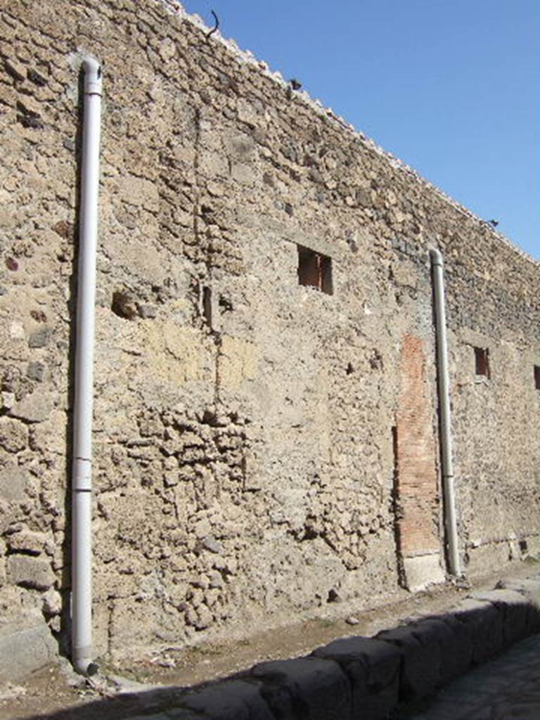 VII.5.17 Pompeii. September 2005. Looking north-east towards site of entrance doorway. According to Garcia y Garcia, all of the south-west corner and southern part of the insula were transformed in the time of Maiuri. Then the area was hit during the first bombing incursion during the early evening (17.00hrs) of 13th September 1943. All of the old structures that remained have been modified again to provide a restaurant, toilets and sales area. The modifications included closing and bricking up of the old doorways to VII.5.14, 15, 16 and 17. Entrances at VII.5.18, 19 and 20 now provide the doorways to the modern restaurant. 
See Garcia y Garcia, L., 2006. Danni di guerra a Pompei. Rome: LErma di Bretschneider. (p.101-3).
