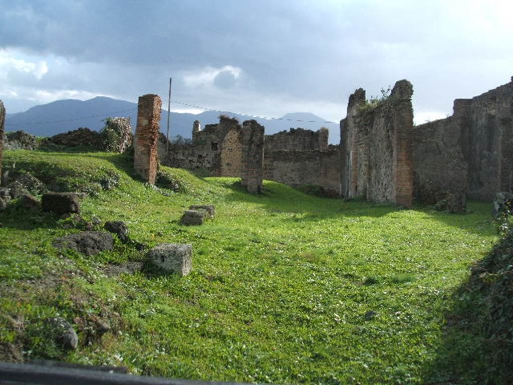 VII.6.3 Pompeii. December 2004. Looking south from fauces 2 across site of atrium 3a to tablinum 12 and viridarium 18. On the front left is room 3 which is higher than the rest of the house. Excavations by the Universidad Complutense de Madrid in 2010 have shown this room covers a previously unknown vaulted basement. Next to the white stone block there are steps up from the fauces to the higher floor of the room. See http://www.dianaarcaizante.com/ . In January 1761, two seal/signets were found in this area.