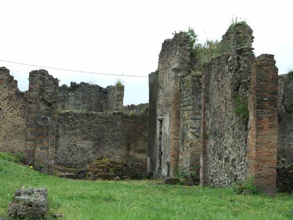 VII.6.3 Pompeii. May 2010. Looking through tablinum 12 to viridarium 18 on south side.
According to Jashemski – “The garden at the rear of the house had a portico on the north and part of the east sides.
By the time of the eruption, two of the original columns on the north side had been reinforced with pillars, the third one replaced with a pillar.
They were connected by a low masonry wall with the entrance to the garden on the north.
A water channel of Nucerian tufa outlined the garden, collecting the water from the roof which was carried by two large terracotta pipes built in the north-west and south-east corners. The water was presumably stored in a cistern.”
See Jashemski, W. F., 1993. The Gardens of Pompeii, Volume II: Appendices. New York: Caratzas. (p.184)

