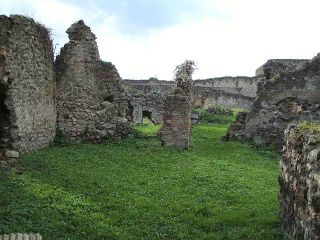 VII.6.16 Pompeii. Looking west to site of rear room (on left), and corridor leading to VII.6.11 (on right).
