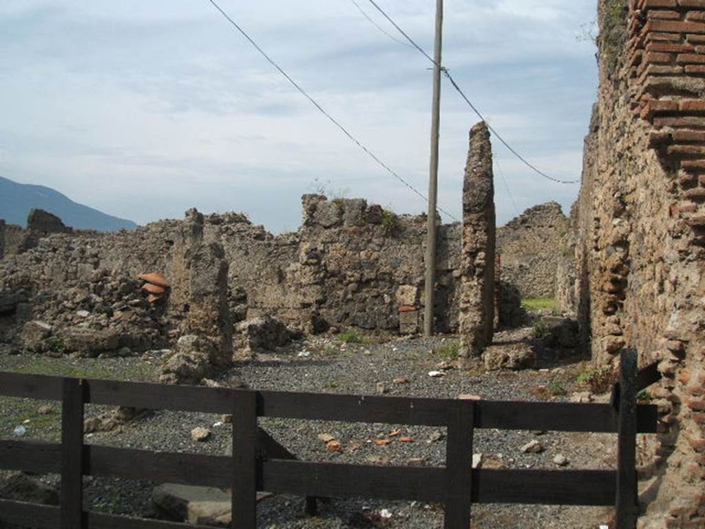 VII.6.19 Pompeii. May 2005. Looking west. According to Eschebach, on the north side (right) was a stairs to the upper floor. On the south side, (left) was a sales-table, together with doorway to VII.6.20. On the west side, the rear room had a doorway to VII.6.28 with 4 dormitories behind VII.6.17 &18, for the workers?
See Eschebach, L., 1993. Gebudeverzeichnis und Stadtplan der antiken Stadt Pompeji. Kln: Bhlau. (p.296)
