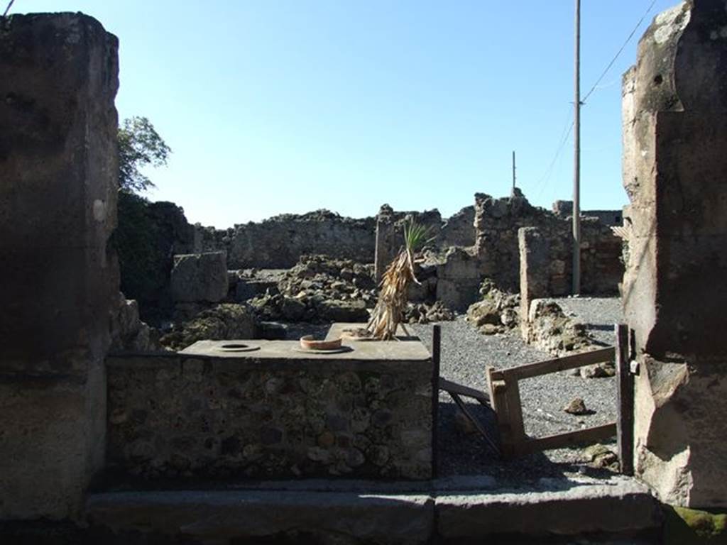 VII.6.20 Pompeii. March 2009. Looking west across sales-room with two sided counter with 3 urns and a hearth. 
According to Della Corte, this small dwelling annexed to another caupona was lived in by a pompeian, known only by the initials M. C. N.
Written on the dado of an internal rooms was - M. C. N. pecunia  sua  f(e)c(it)     [CIL IV 495]  See Della Corte, M., 1965.  Case ed Abitanti di Pompei. Napoli: Fausto Fiorentino. (p.173)
According to Epigraphik-Datenbank Clauss/Slaby (See www.manfredclauss.de), this read
M(arcus)  C()  N()  pecunia  sua      [CIL IV 495]
