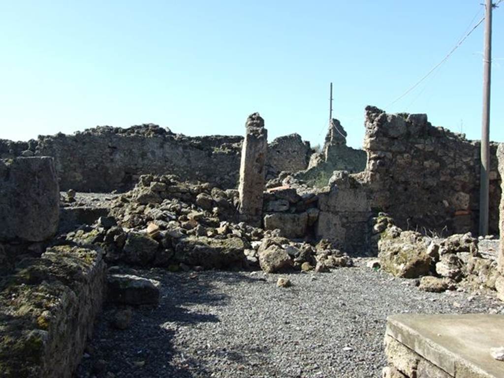 VII.6.20 Pompeii. March 2009. Looking west towards site of rear room, and small yard or garden. 
This site would be approximately under the pile of stones.
According to Eschebach, on the north side (right) would have been separate steps to the upper floor dwelling above the doorway to VII.6.19.
On the west side would have been a rear room, a second stairs to the upper floor, a latrine and a small yard and garden.
See Eschebach, L., 1993. Gebudeverzeichnis und Stadtplan der antiken Stadt Pompeji. Kln: Bhlau. (p.296)

