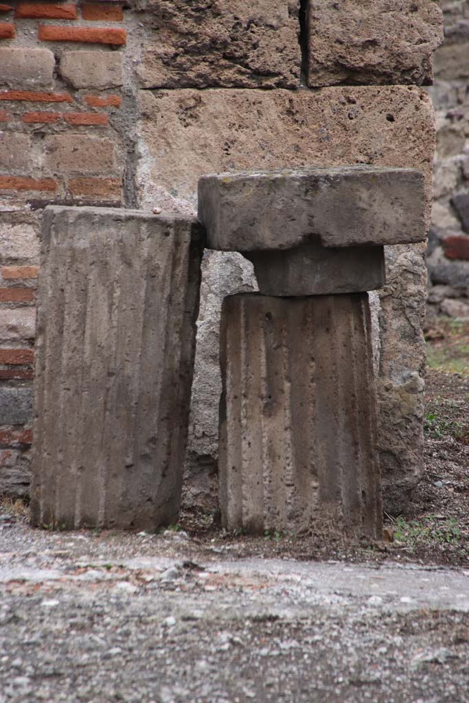 VII.7.10/13 Pompeii. 1932. Base of money-chest found on east side of atrium.
According to Pernice -
Found in the atrium on the right wall in front of the Ala. Base of a money chest made of lava. 
In the middle is a lead-cast iron spike. The corners are notched for right-angled feet.
See Pernice, E., 1932. Hellenistische Tische, Zisternenmündungen, Beckenuntersätze, Altäre u. Truhen. Berlin, p. 72, Taf. 43.2.
DAIR 32.1107. Photo © Deutsches Archäologisches Institut, Abteilung Rom, Arkiv. 
Thanks to Espen B. Andersson for assisting us in our interest in money-chests.

