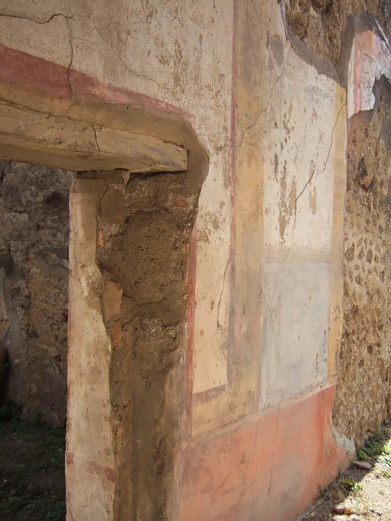 VII.7.13 Pompeii. September 2005. Remains of painted wall decoration on east wall of peristyle.