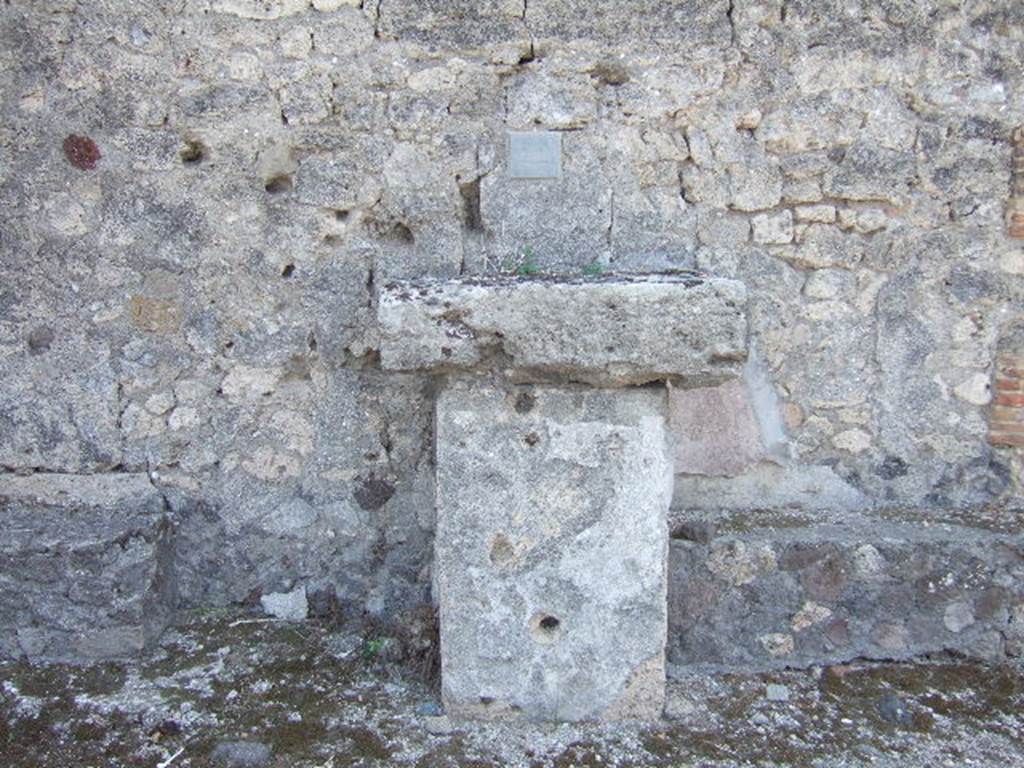 VII.7.22 Pompeii. September 2005. Street altar. According to Mau, above the altar was a stucco relief representing a sacrifice; at the sides of the relief were pilasters. Above the relief was a gable, in which an eagle could be seen. The eagle indicated that the shrine was dedicated to Jupiter.
See Mau, A., 1907, translated by Kelsey, F. W., Pompeii: Its Life and Art. New York: Macmillan, (p. 235).
