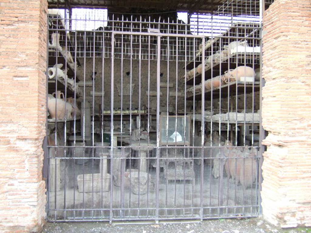 VII.7.29 Pompeii. May 2006. Looking west through entrance doorway towards items in storage.