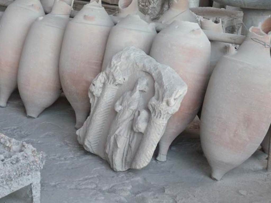 VII.7.29 Pompeii. September 2015. Sculpted plaque with female figure between columns and amphorae in storage.