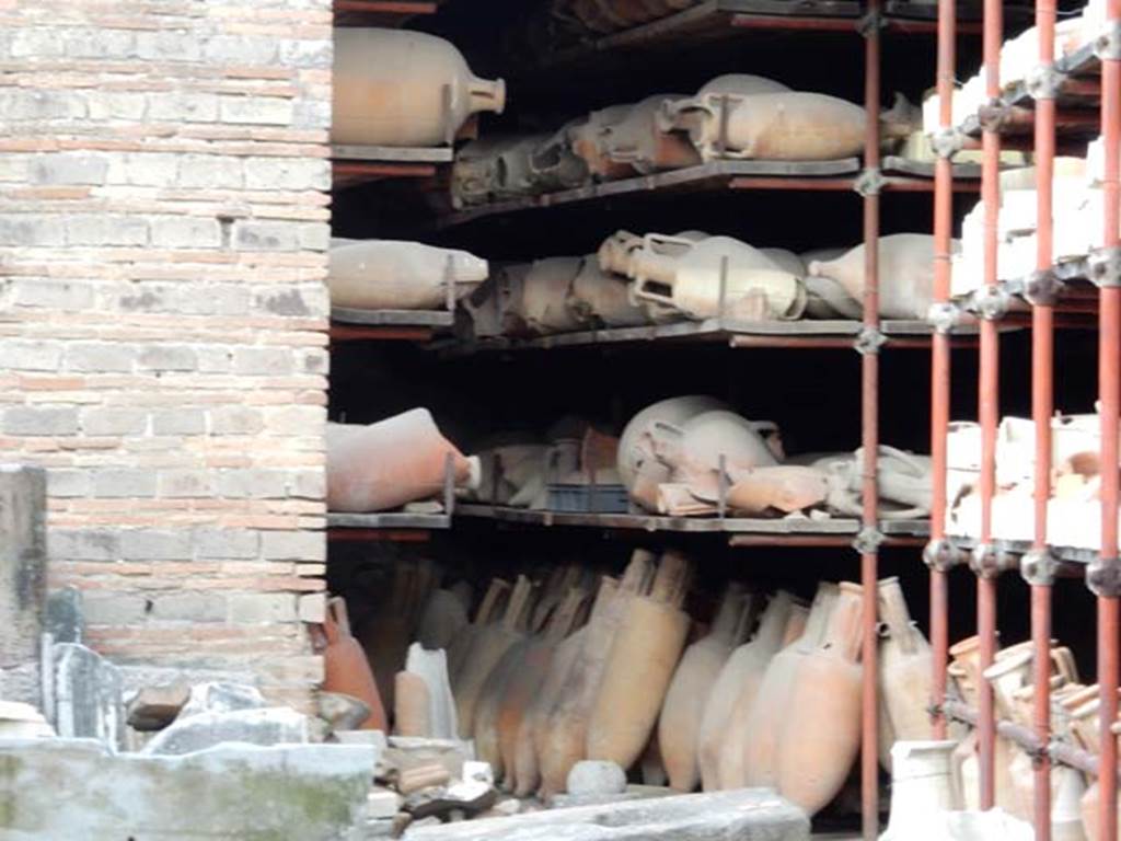 VII.7.30 Pompeii. May 2015. Looking towards west end from entrance doorway, and amphorae in storage. Photo courtesy of Buzz Ferebee.
