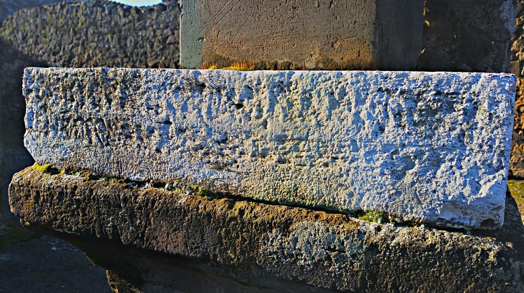 VII.7.32 Pompeii. December 2019. 
Looking south-west to inscribed stone at base of statue of Artemis. Photo courtesy of Giuseppe Ciaramella.

