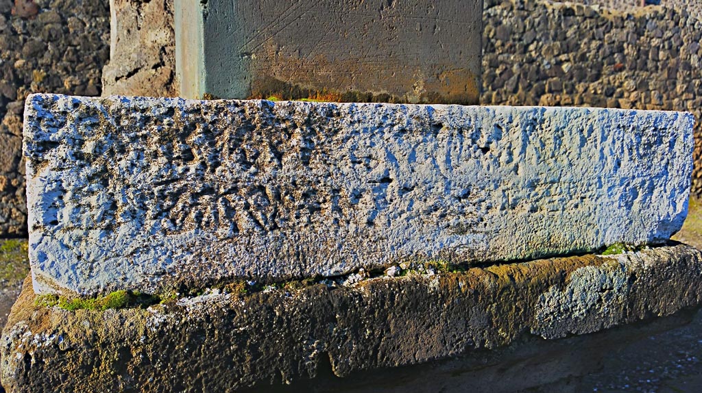 VII.7.32 Pompeii. December 2019. 
Looking west to inscribed stone at base of statue of Artemis. Photo courtesy of Giuseppe Ciaramella.


