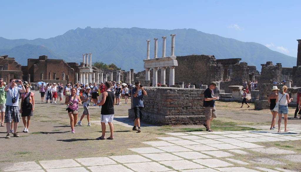 VII.8 Pompeii. July 2012. 
Looking south-west across Forum. Note there are no horizontal beams at the top of the upper rows of columns.
Photo courtesy of John Vanko. His father took the identical photo in February 1952, see below.
