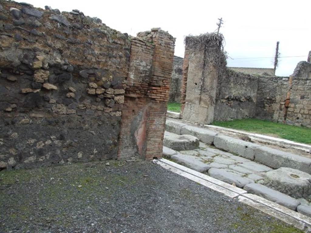 VII.9.29 Pompeii. March 2009. West wall, north west corner. Marble sill and entrance onto Via degli Augustali.