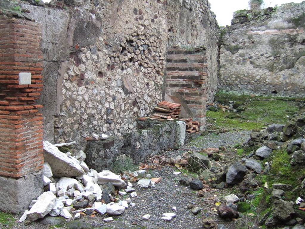 VII.9.44 Pompeii. December 2005. Looking south-east across entrance doorway.  According to Eschebach on the left would have been the remains of the base two steps of the stairs to the upper floor. See Eschebach, L., 1993. Gebudeverzeichnis und Stadtplan der antiken Stadt Pompeji. Kln: Bhlau. (p.316)
 