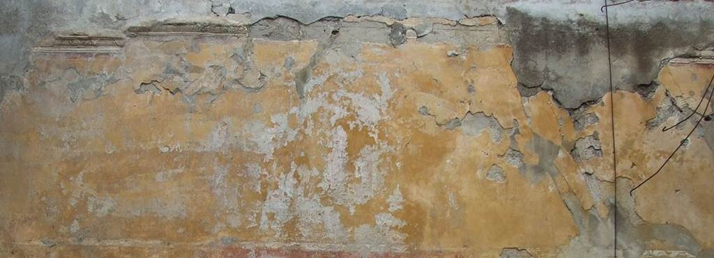 VII.9.47 Pompeii. March 2009. Room 11. Oecus. North wall frieze. Remains of the painting of the Temple of Venus. With imagination, the folds of the dress of the statue may just be seen, and perhaps the remains of the face of Hebe.