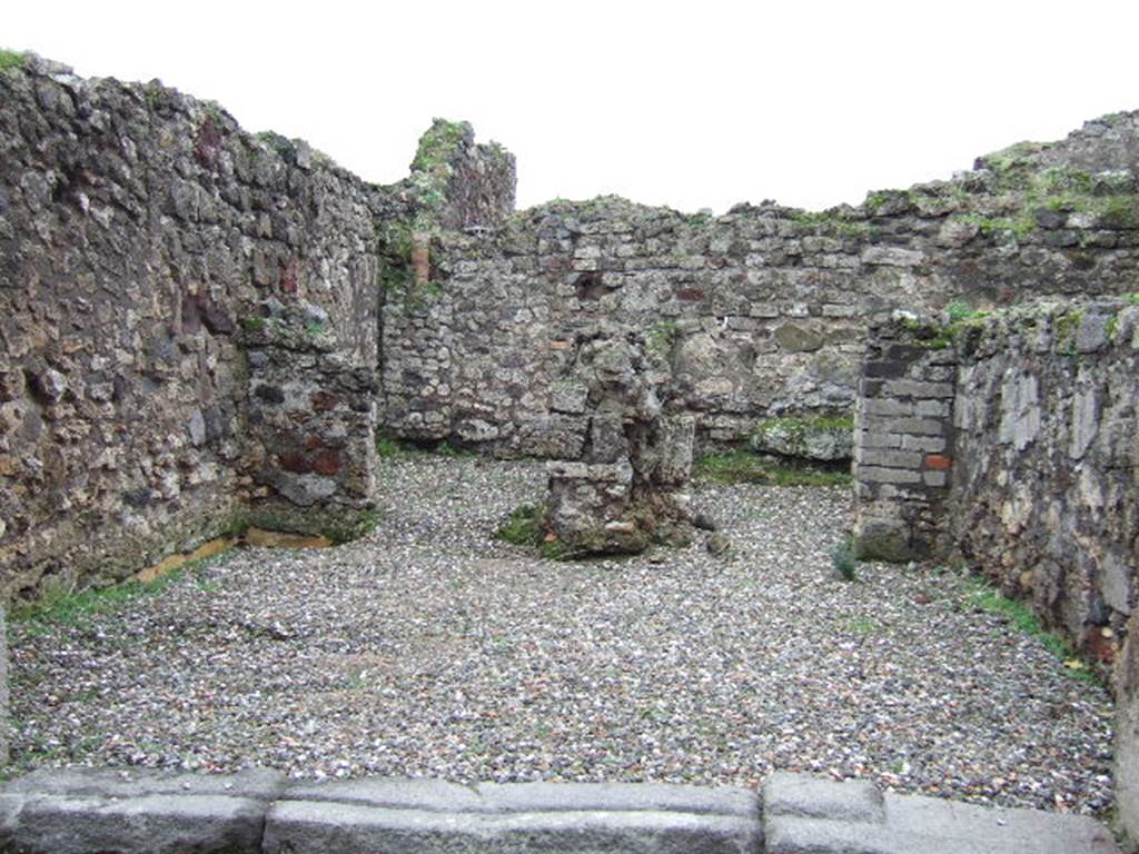 VII.9.50 Pompeii.  December 2005. Looking south across shop, to two rear rooms. According to Fiorelli, the shop had a counter with a simple hearth and at the rear were two rooms, one with the usual staircase.  See Pappalardo, U., 2001. La Descrizione di Pompei per Giuseppe Fiorelli (1875). Napoli: Massa Editore.(p107)  According to Liselotte Eschebach, to the left was a rear room with a hearth, and a downpipe from latrine on upper floor. To the right was another room with a staircase to the upper floor.  See Eschebach, L., 1993. Gebudeverzeichnis und Stadtplan der antiken Stadt Pompeji. Kln: Bhlau. (p317)
