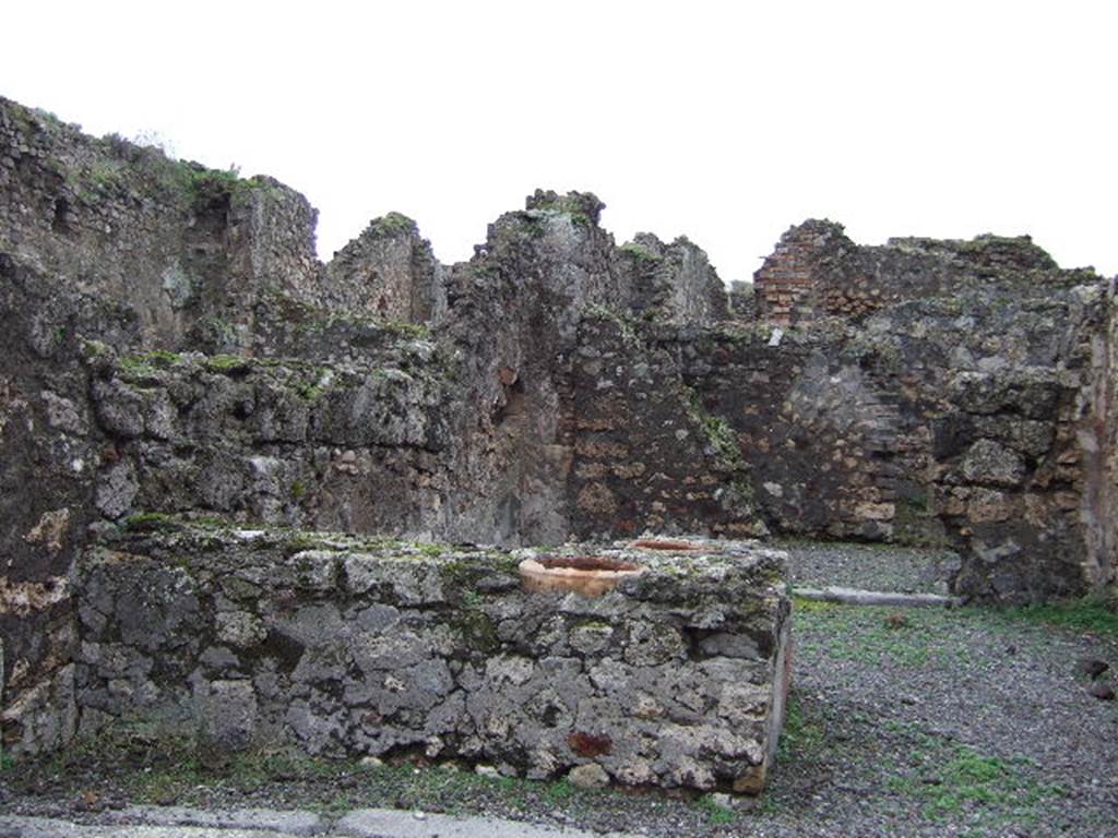 VII.9.57 Pompeii. December 2005. Looking west across counter towards rear room. 