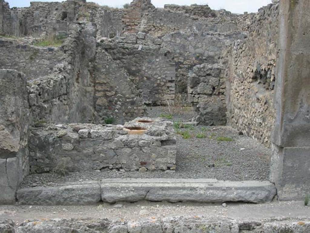 VII.9.57 Pompeii. May 2003. Looking west from entrance across counter towards doorway to rear room. Photo courtesy of Nicolas Monteix.
