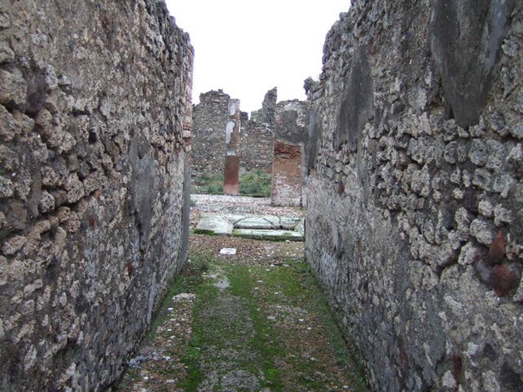 VII.10.5 Pompeii. December 2005. Entrance corridor, looking east to atrium.  The long fauces stretched eastward, to the detriment of the atrium. The moving and renewing of the impluvium also required the creation of a new emptying system, which meant breaking and relaying the previous atrium and fauces flooring. This resulted in the patches, seen above, in the fauces flooring.
Studi della Soprintendenza archeologica di Pompei, 22: l'Insula VII, 10 di Pompei , by Angelo Amoroso. (p.80)
