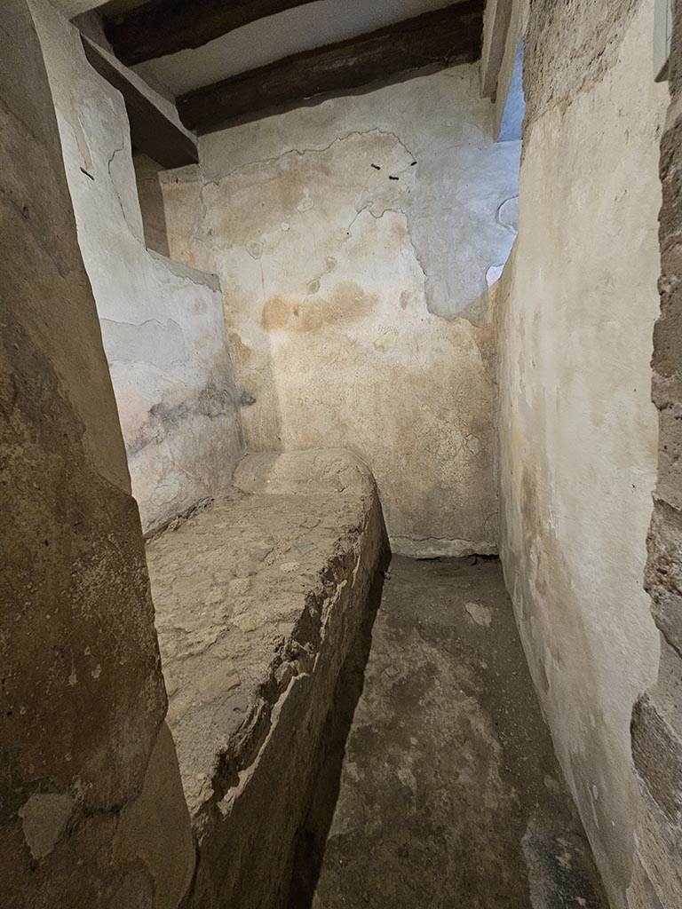 VII.12.18 Pompeii. November 2024. 
Looking north into room for prostitute with stone bed. Photo courtesy of Annette Haug.
