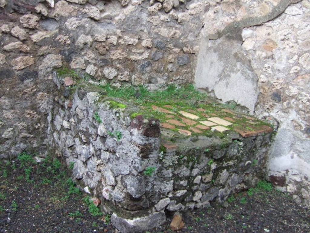 VII.13.8 Pompeii. December 2005. Hearth or bench in north-west corner of kitchen.