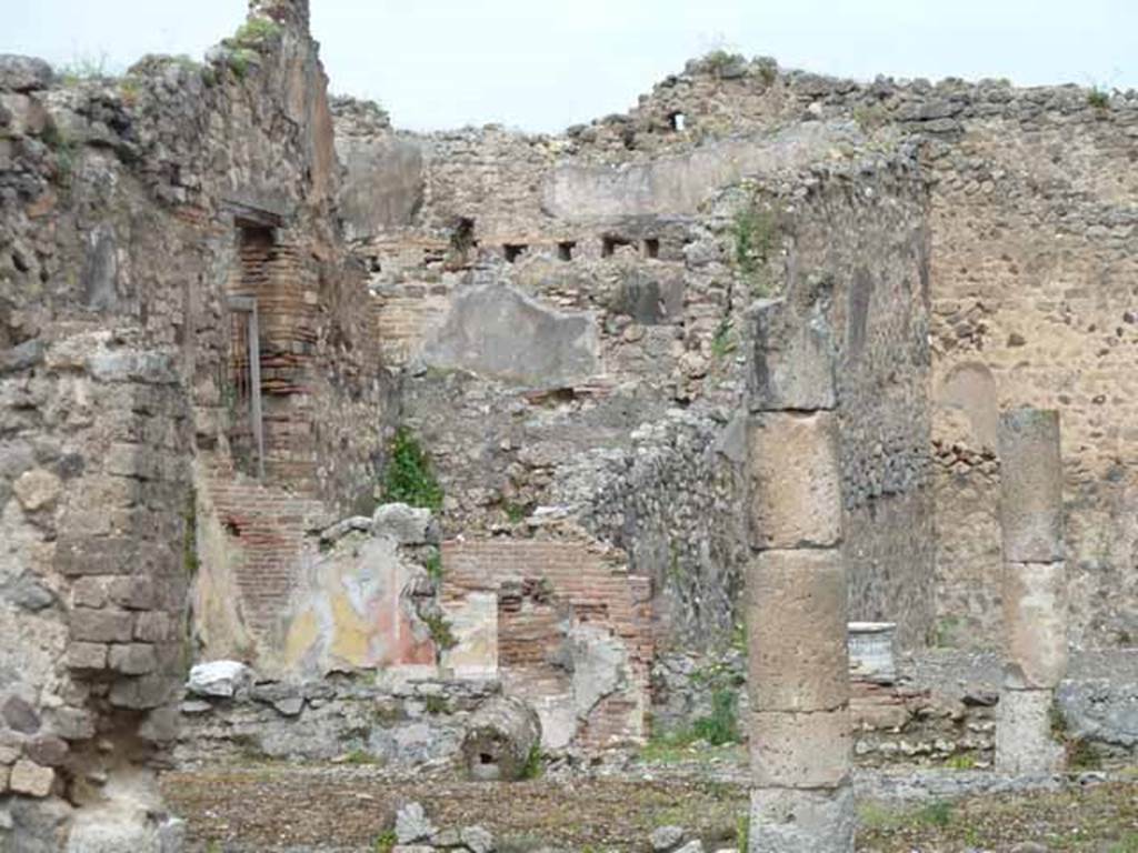 VII.13.21 Pompeii. May 2010. Looking north-west from VII.13.4. Looking towards rear triclinium room and gated doorway leading west to bar-room. 
