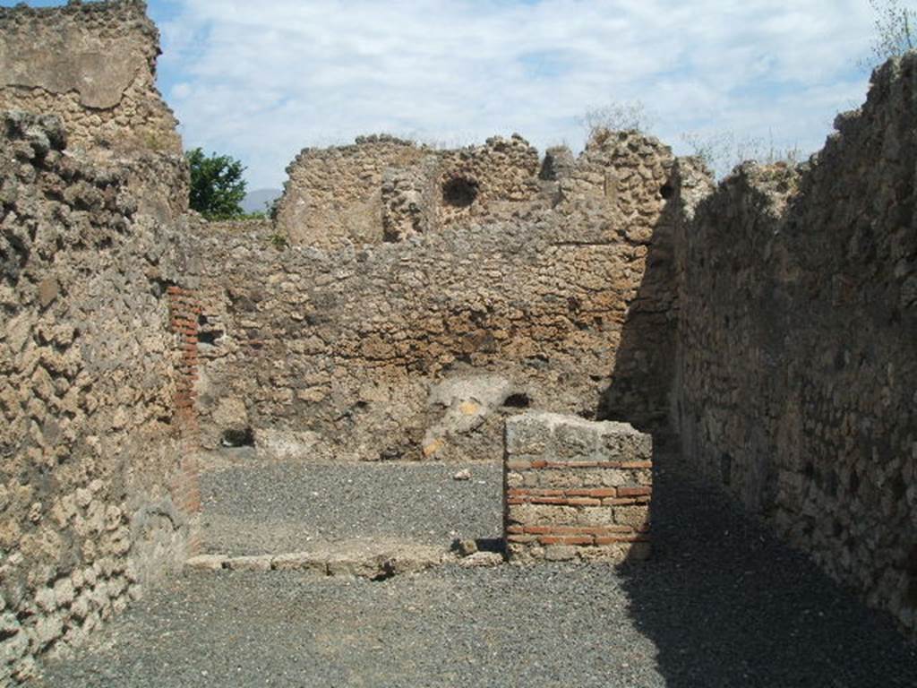 VII.14.12 Pompeii. May 2005. Looking north across shop-room to two entrances to rear room.