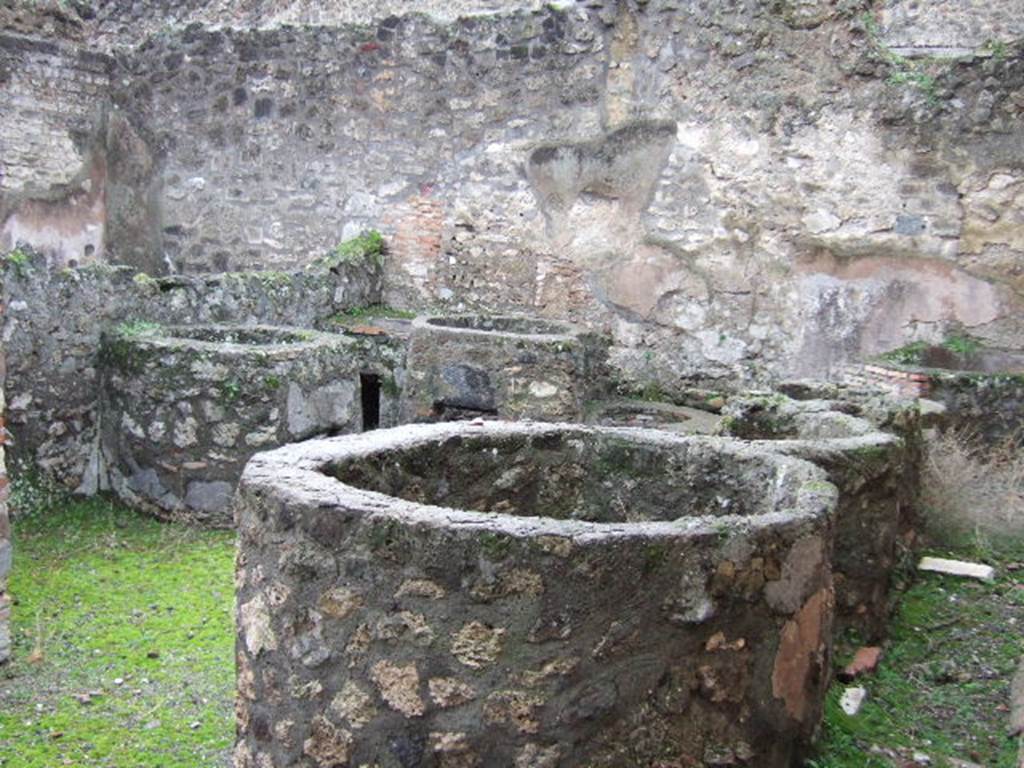 VII.14.17 Pompeii.  December 2005.  Looking west from entrance across vats with built in hearth.