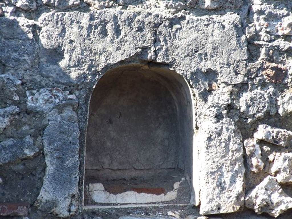 VII.16.7 Pompeii. March 2009. West wall, southern end.  Arched niche with a low step, as described by Boyce.  See Boyce G. K., 1937. Corpus of the Lararia of Pompeii. Rome: MAAR 14.  (p73, No.337)
