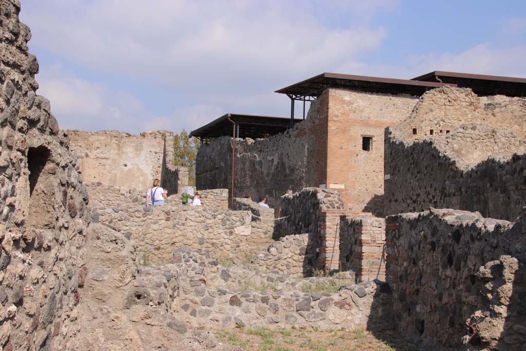 VII.16.7 Pompeii. September 2019. Looking north from area of rear room, towards doorways of VII.16.8/9 and 10 on Vicolo del Gigante.
Photo courtesy of Klaus Heese.
