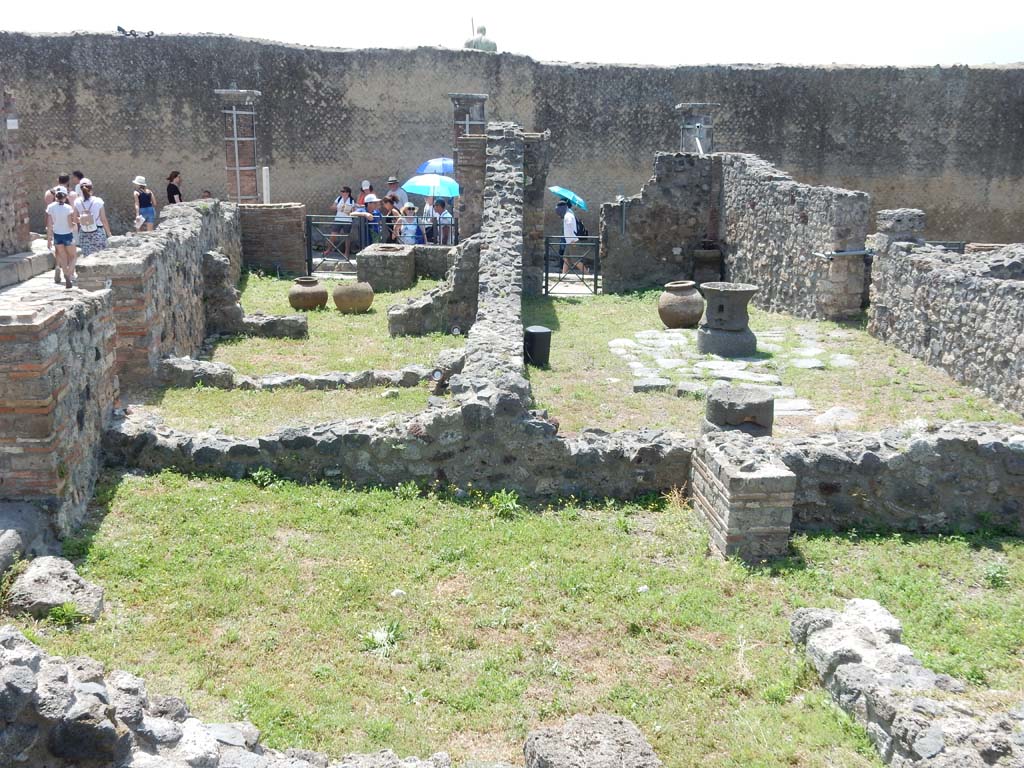 VII.16.7 Pompeii on left, and VII.16.6 on right. June 2019. 
Looking south from remains of bakery at VII.16.9, across VII.16.8, on left, towards rear room of VII.16.7, upper left, and on towards entrance doorway onto Via Marina. 
Photo courtesy of Buzz Ferebee.

