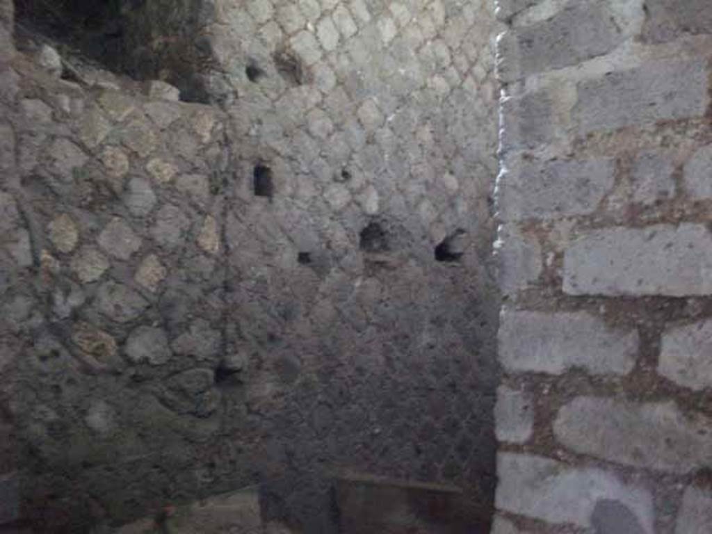 VII.16.a Pompeii. May 2010.Room 11, north end of corridor, looking east behind the deep well wall.