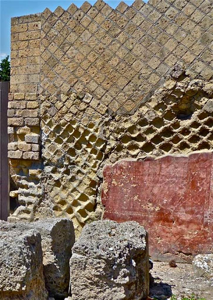 VII.16.a Pompeii. May 2011. Remains of painted wall stucco on east side of doorway to rooms on upper level of Suburban Baths, looking north. Photo courtesy of Michael Binns.

