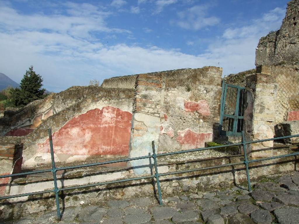 VII.16.a Pompeii. September 2005. Entrance to upper floor, and exterior wall with painted plaster.
